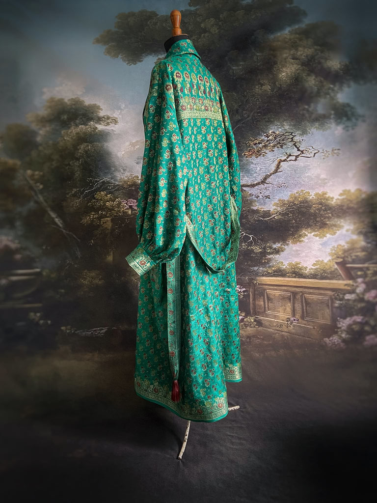 Turquoise green light silk brocade wrapper robe with full sleeves, large patch pockets and tassel sash. Bohemian style sustainably created from antique and vintage textiles by the Pavilion Parade studio.