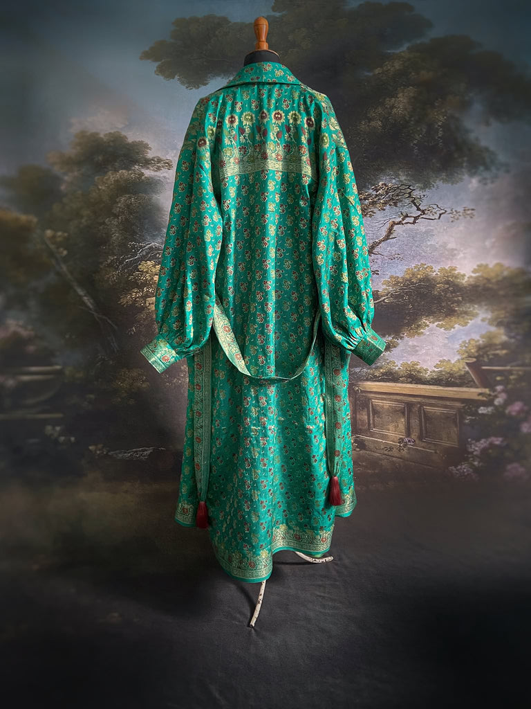 Turquoise green light silk brocade wrapper robe with full sleeves, large patch pockets and tassel sash. Bohemian style sustainably created from antique and vintage textiles by the Pavilion Parade studio.