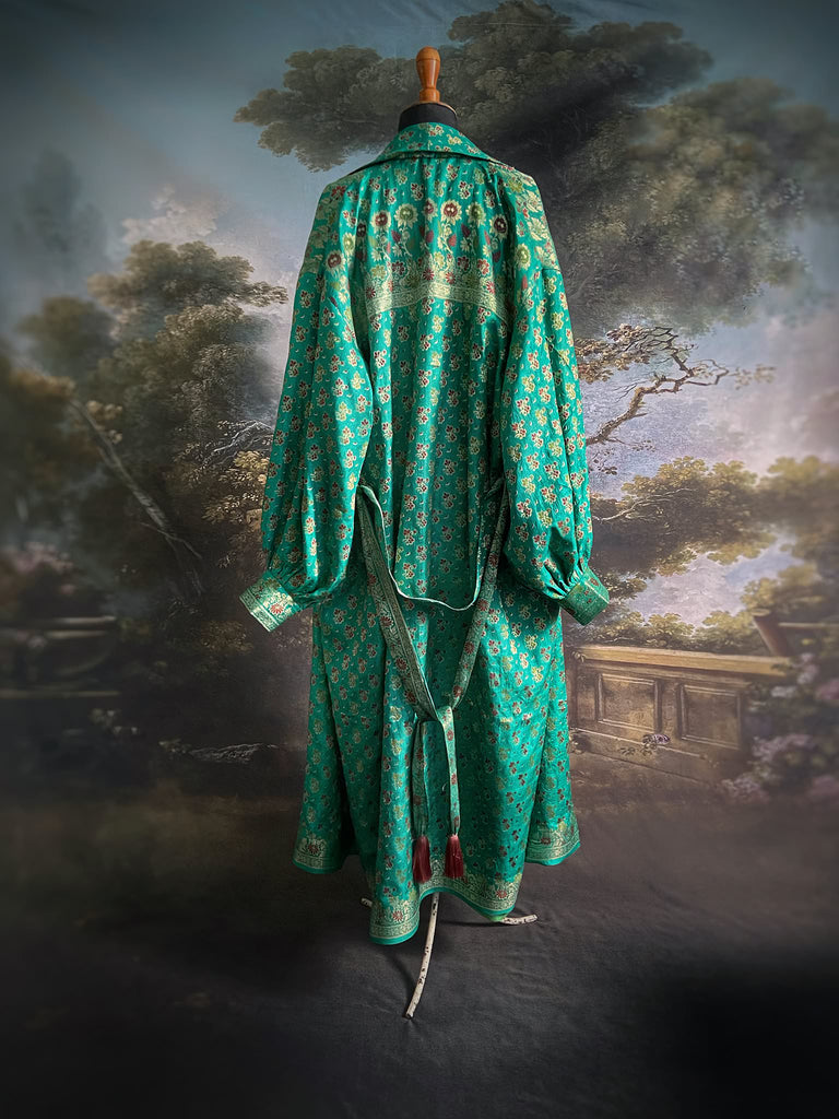 Turquoise green light silk brocade wrapper robe with full sleeves, large patch pockets and tassel sash. Bohemian style sustainably created from antique and vintage textiles by the Pavilion Parade studio.