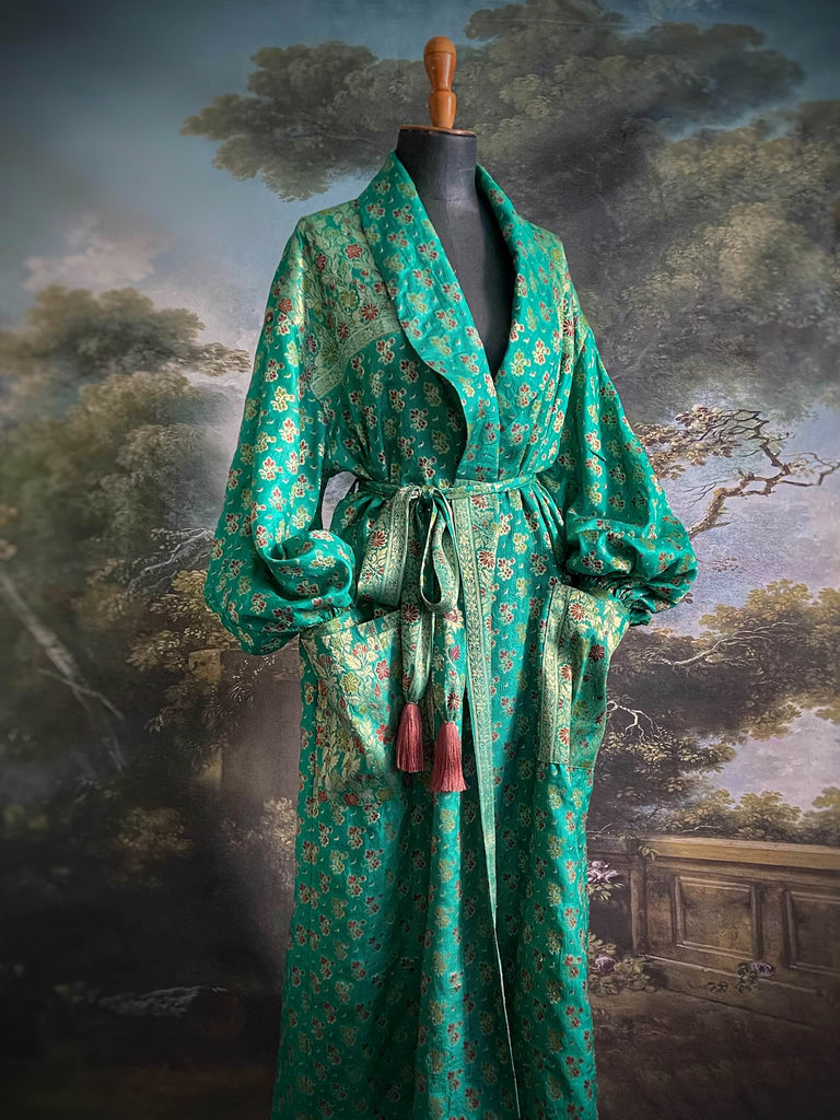 Turquoise green light silk brocade wrapper robe with full sleeves, large patch pockets and tassel sash. Bohemian style sustainably created from antique and vintage textiles by the Pavilion Parade studio.