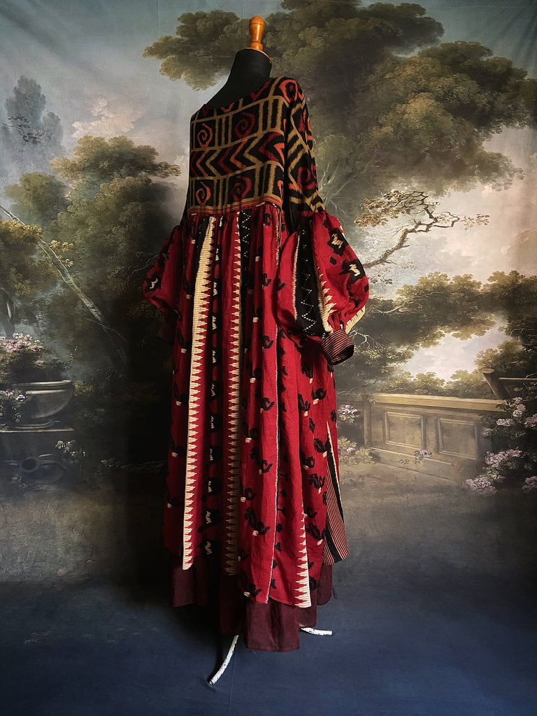 Artistic Dress inspired scarlet and black ikat printed Indian cotton muslin dress  with balloon sleeves, pockets, and integral tiered petticoat. Bohemian style sustainably created from vintage and antique textiles by the Pavilion Parade studio. 