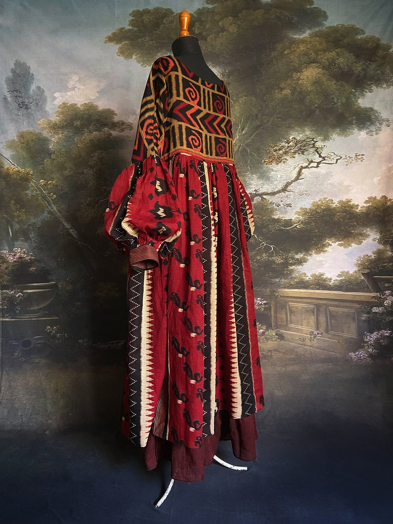 Artistic Dress inspired scarlet and black ikat printed Indian cotton muslin dress  with balloon sleeves, pockets, and integral tiered petticoat. Bohemian style sustainably created from vintage and antique textiles by the Pavilion Parade studio. 