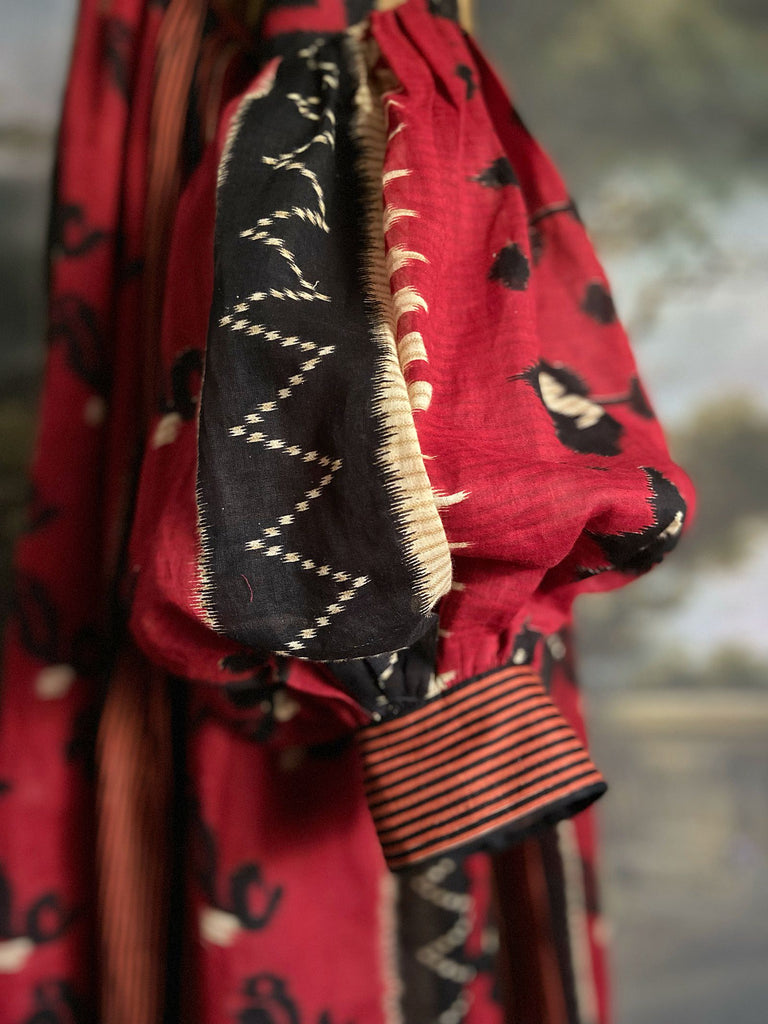 Artistic Dress inspired scarlet and black ikat printed Indian cotton muslin dress  with balloon sleeves, pockets, and integral tiered petticoat. Bohemian style sustainably created from vintage and antique textiles by the Pavilion Parade studio. 