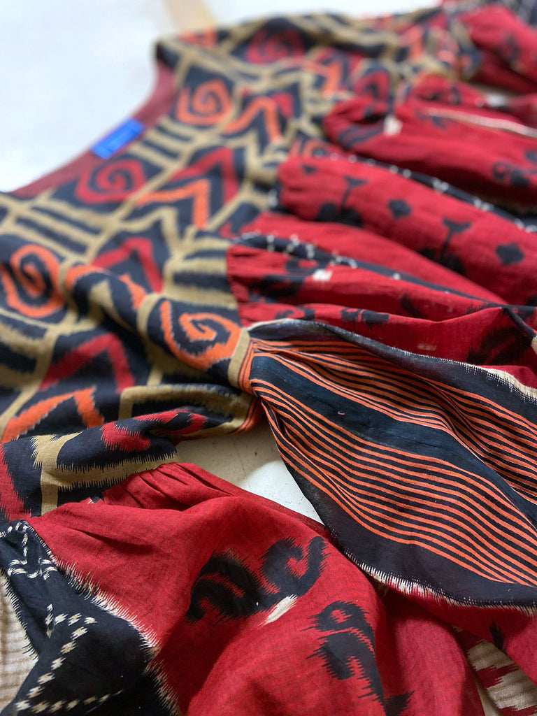 Artistic Dress inspired scarlet and black ikat printed Indian cotton muslin dress  with balloon sleeves, pockets, and integral tiered petticoat. Bohemian style sustainably created from vintage and antique textiles by the Pavilion Parade studio. 