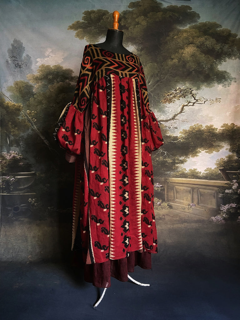 Artistic Dress inspired scarlet and black ikat printed Indian cotton muslin dress  with balloon sleeves, pockets, and integral tiered petticoat. Bohemian style sustainably created from vintage and antique textiles by the Pavilion Parade studio. 