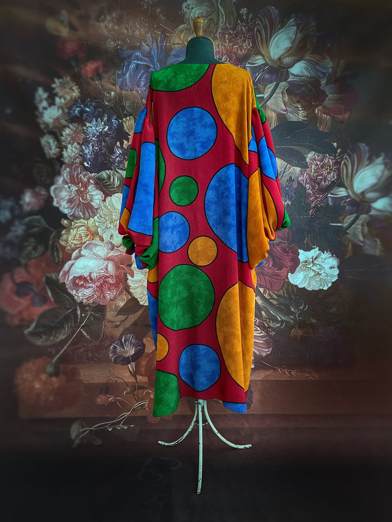 Vibrant silk crepe relaxed fit dress with full balloon sleeves, V neck and pockets. Printed design of giant oversize polka dot spots. Bohemian style created from antique and vintage textiles by the Pavilion Parade studio.