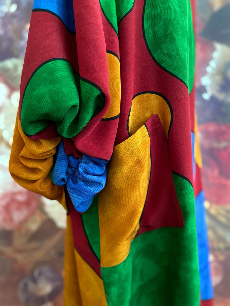 Vibrant silk crepe relaxed fit dress with full balloon sleeves, V neck and pockets. Printed design of giant oversize polka dot spots. Bohemian style created from antique and vintage textiles by the Pavilion Parade studio.