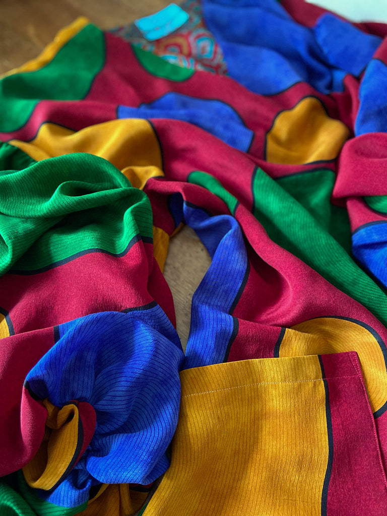 Vibrant silk crepe relaxed fit dress with full balloon sleeves, V neck and pockets. Printed design of giant oversize polka dot spots. Bohemian style created from antique and vintage textiles by the Pavilion Parade studio.