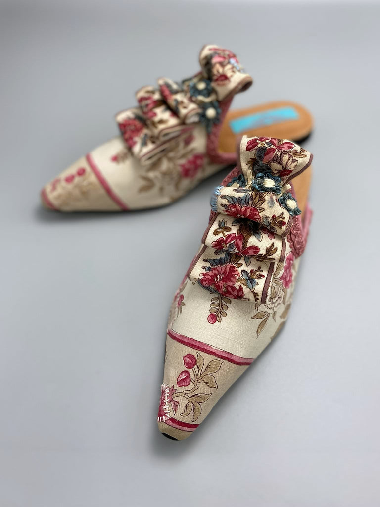 Pompadour Marie Antoinette inspired shoes created from antique early 1800s rose pink and ivory block printed French cotton toile and embellished in blue silk passementerie rosettes. Bohemian style from the Pavilion Parade studio.