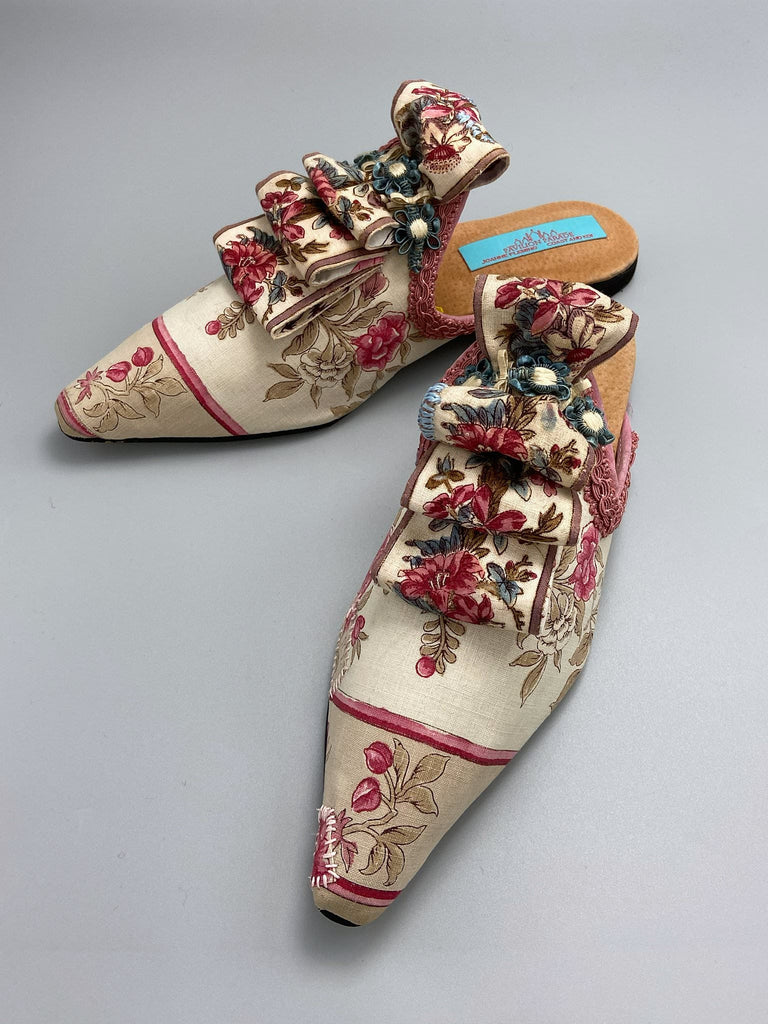 Pompadour Marie Antoinette inspired shoes created from antique early 1800s rose pink and ivory block printed French cotton toile and embellished in blue silk passementerie rosettes. Bohemian style from the Pavilion Parade studio.