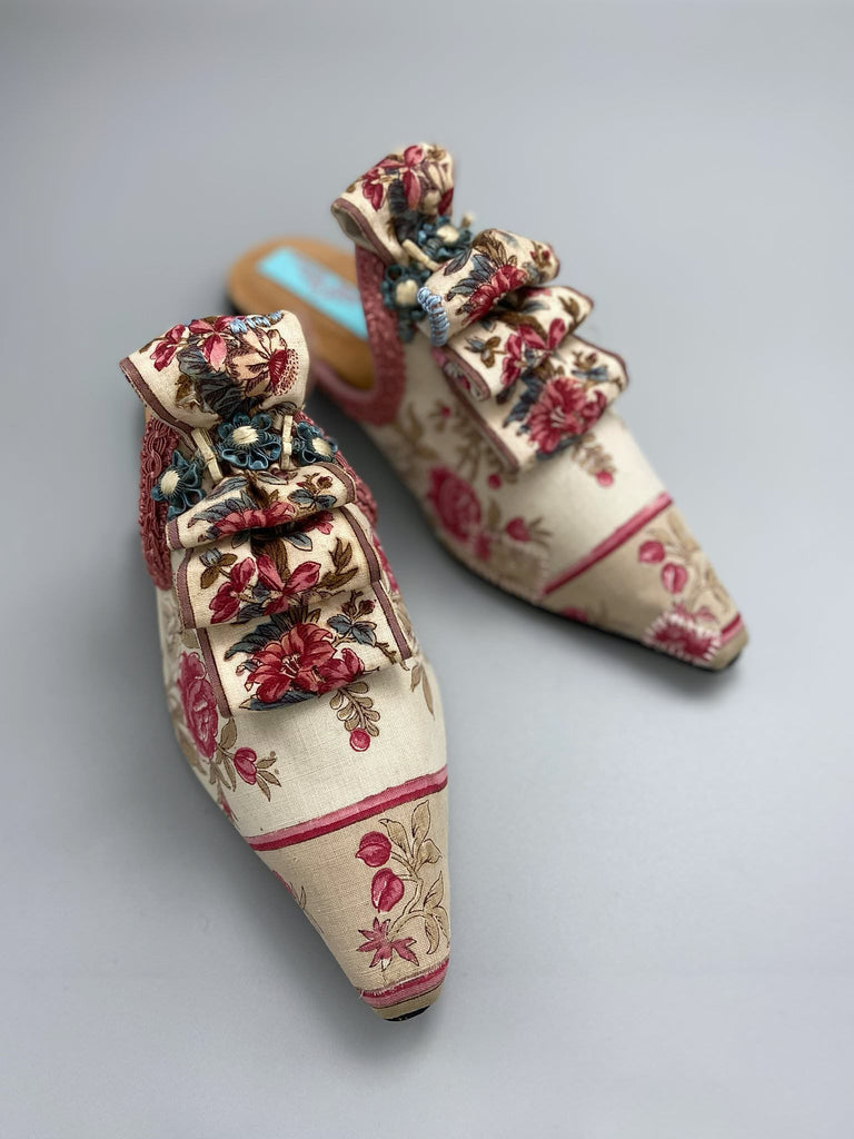 Pompadour Marie Antoinette inspired shoes created from antique early 1800s rose pink and ivory block printed French cotton toile and embellished in blue silk passementerie rosettes. Bohemian style from the Pavilion Parade studio.