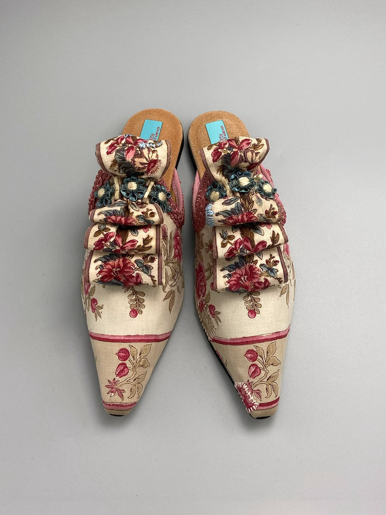 Pompadour Marie Antoinette inspired shoes created from antique early 1800s rose pink and ivory block printed French cotton toile and embellished in blue silk passementerie rosettes. Bohemian style from the Pavilion Parade studio.