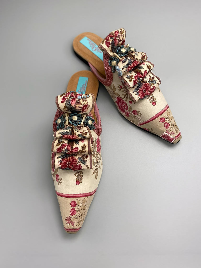 Pompadour Marie Antoinette inspired shoes created from antique early 1800s rose pink and ivory block printed French cotton toile and embellished in blue silk passementerie rosettes. Bohemian style from the Pavilion Parade studio.