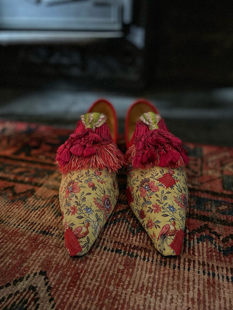 Pavilion Parade handmade shoes created from antique textiles, available from Joanne Fleming Design. 17th century Florentine silk tassels and block printed French Indienne cotton create bohemian flat shoes in shades of yellow, red and blue