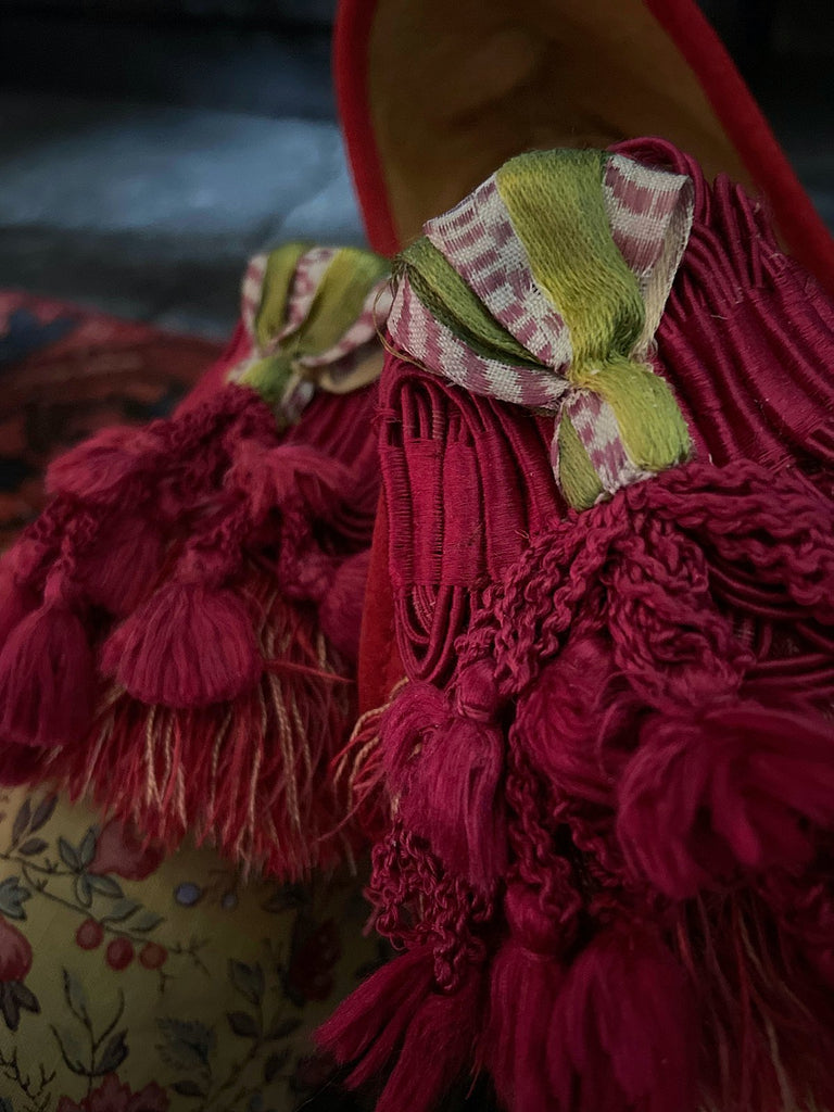 Pavilion Parade handmade shoes created from antique textiles, available from Joanne Fleming Design. 17th century Florentine silk tassels and block printed French Indienne cotton create bohemian flat shoes in shades of yellow, red and blue