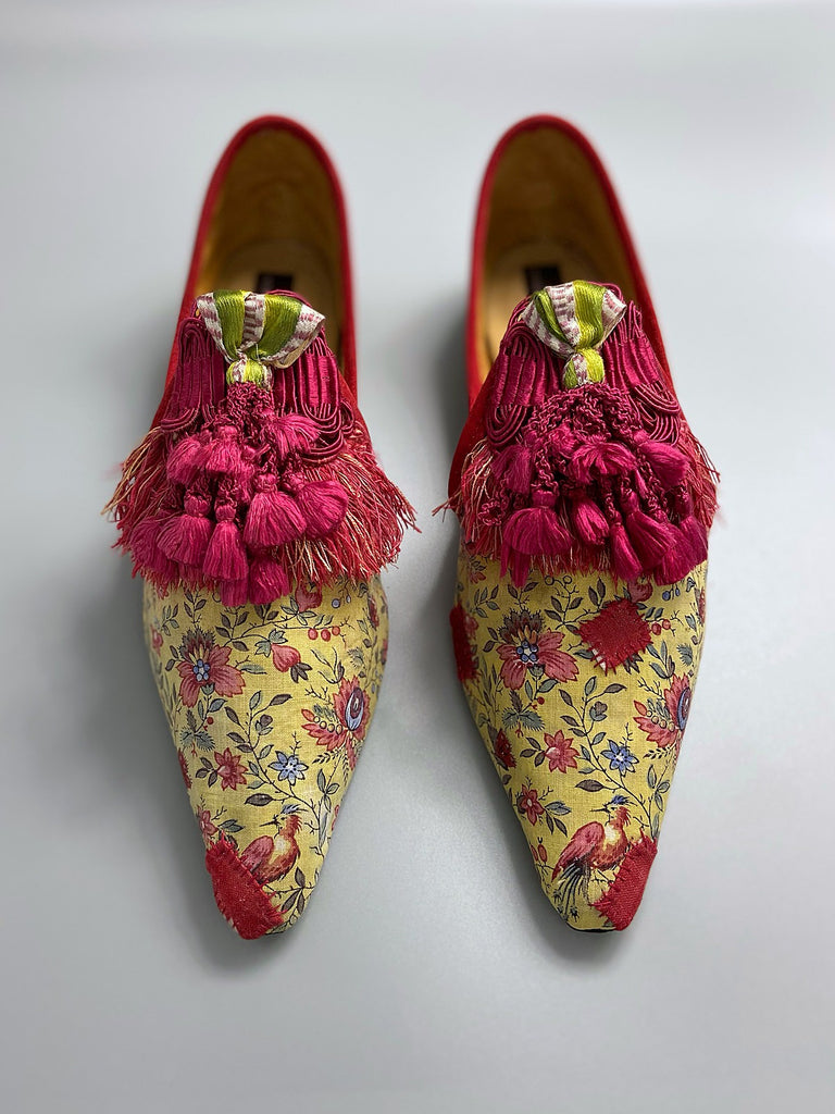 Pavilion Parade handmade shoes created from antique textiles, available from Joanne Fleming Design. 17th century Florentine silk tassels and block printed French Indienne cotton create bohemian flat shoes in shades of yellow, red and blue