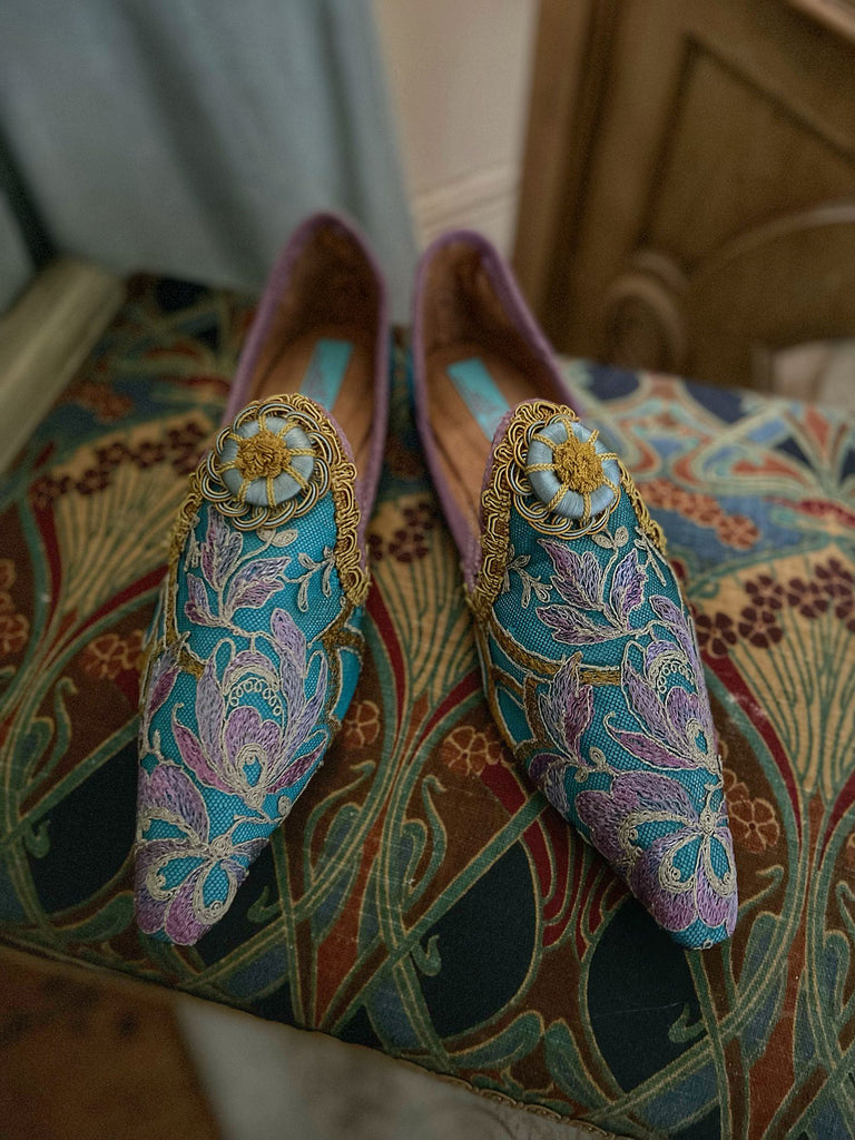 Pointed toe shoes created from antique lilac and gold lace over azure blue silk, with gold braid and vintage Passementerie rosette embellishment. Created by Pavilion Parade.