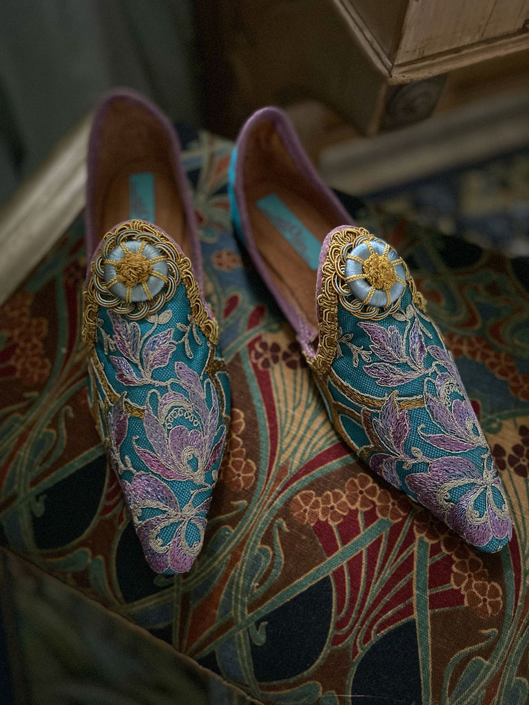 Pointed toe shoes created from antique lilac and gold lace over azure blue silk, with gold braid and vintage Passementerie rosette embellishment. Created by Pavilion Parade.