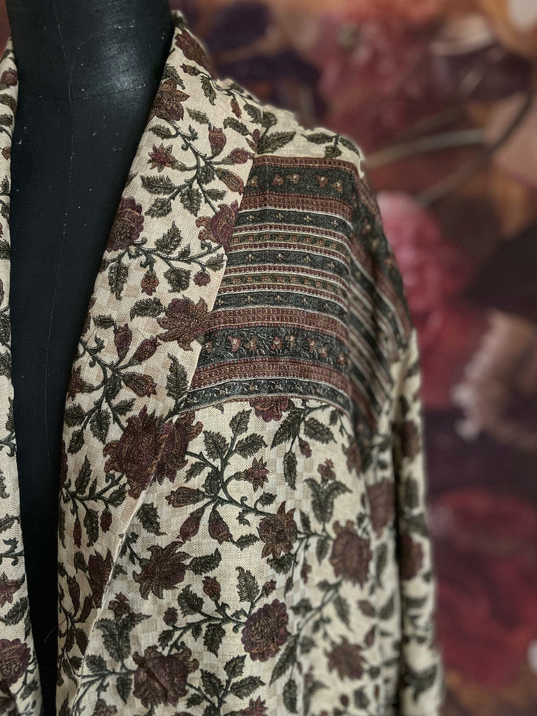 Chestnut brown and olive green fine wool dressing robe or duster coat with a design of Indienne florals. Wide sleeves, deep pockets, tassel sash. Lined in printed silk. Sustainably created from antique and vintage textiles by the Pavilion Parade studio.