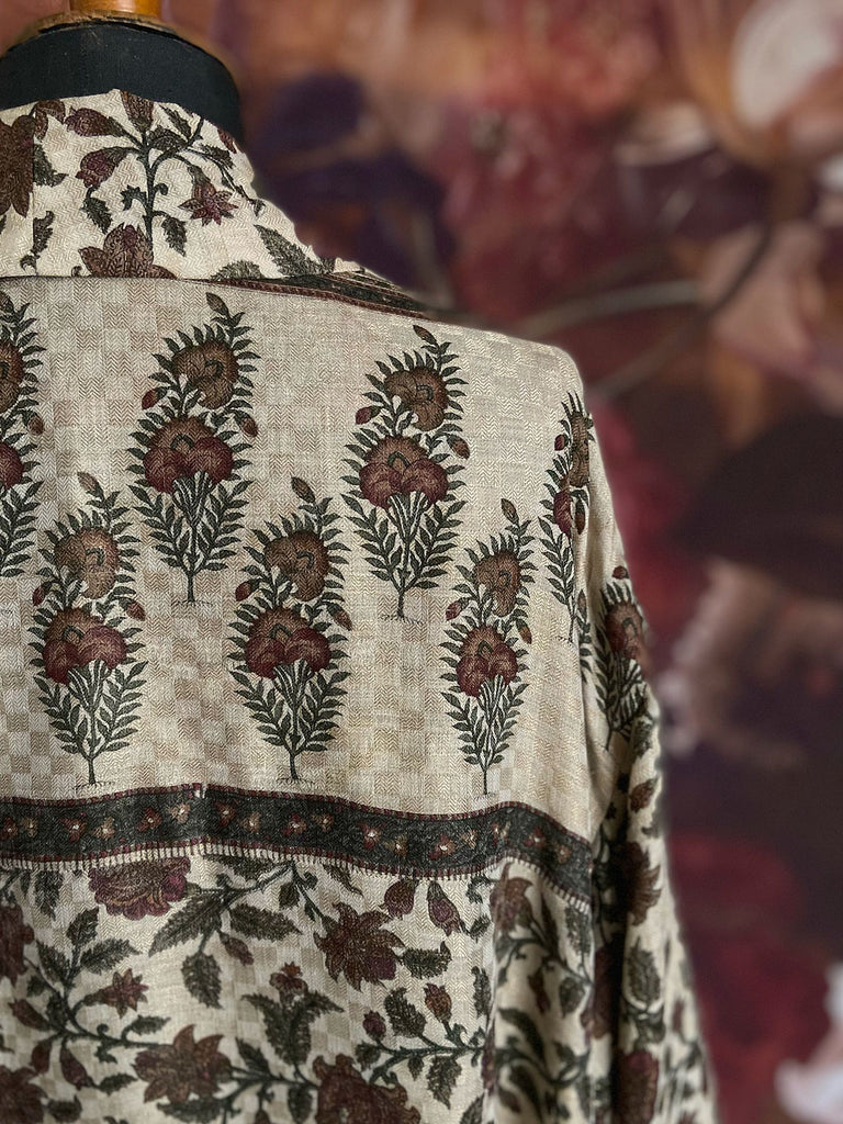 Chestnut brown and olive green fine wool dressing robe or duster coat with a design of Indienne florals. Wide sleeves, deep pockets, tassel sash. Lined in printed silk. Sustainably created from antique and vintage textiles by the Pavilion Parade studio.