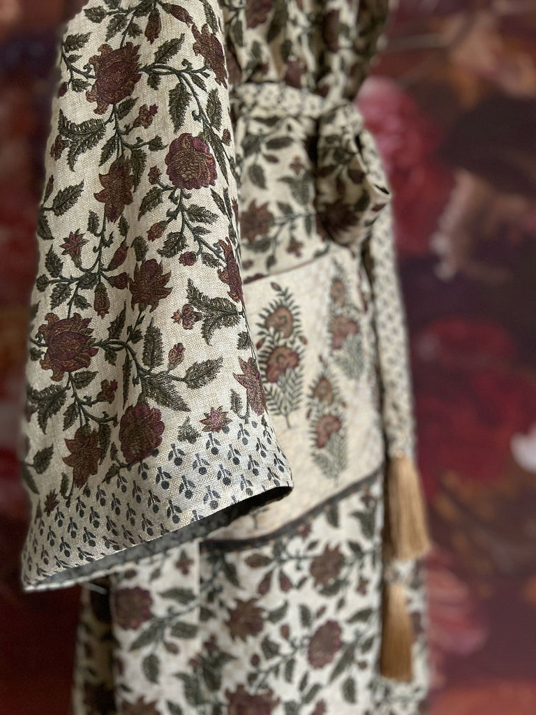 Chestnut brown and olive green fine wool dressing robe or duster coat with a design of Indienne florals. Wide sleeves, deep pockets, tassel sash. Lined in printed silk. Sustainably created from antique and vintage textiles by the Pavilion Parade studio.