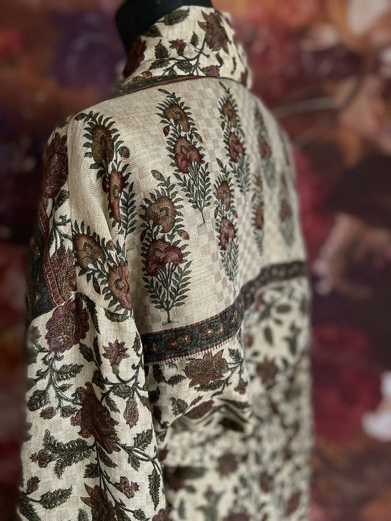 Chestnut brown and olive green fine wool dressing robe or duster coat with a design of Indienne florals. Wide sleeves, deep pockets, tassel sash. Lined in printed silk. Sustainably created from antique and vintage textiles by the Pavilion Parade studio.