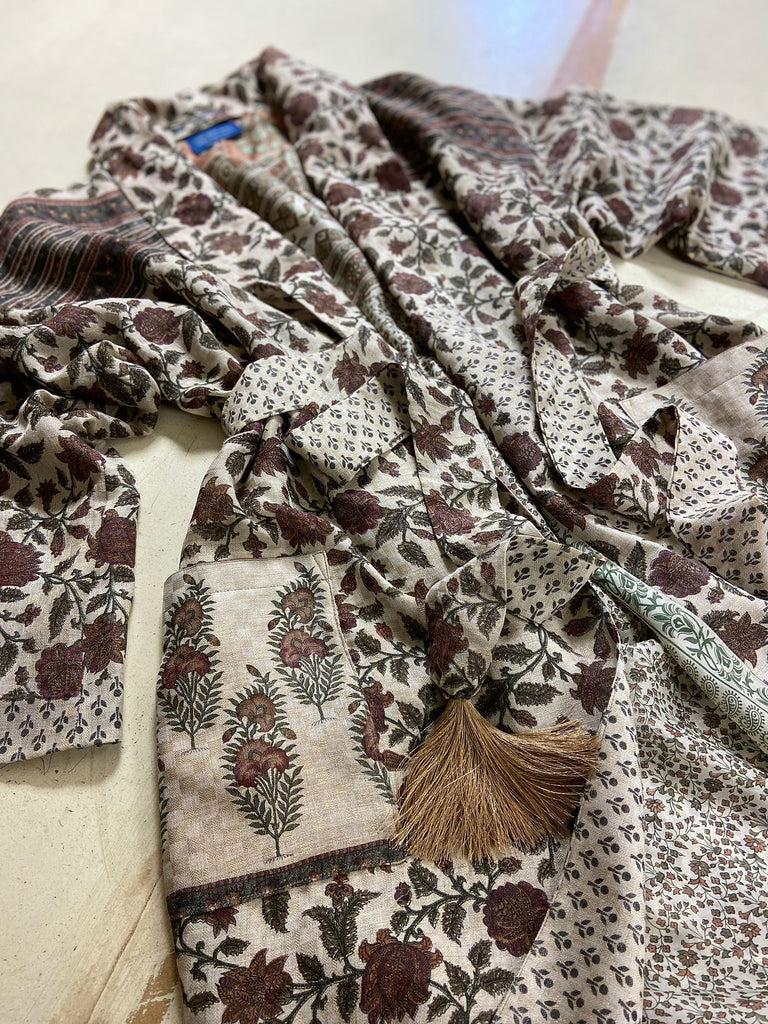 Chestnut brown and olive green fine wool dressing robe or duster coat with a design of Indienne florals. Wide sleeves, deep pockets, tassel sash. Lined in printed silk. Sustainably created from antique and vintage textiles by the Pavilion Parade studio.