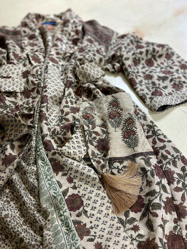Chestnut brown and olive green fine wool dressing robe or duster coat with a design of Indienne florals. Wide sleeves, deep pockets, tassel sash. Lined in printed silk. Sustainably created from antique and vintage textiles by the Pavilion Parade studio.