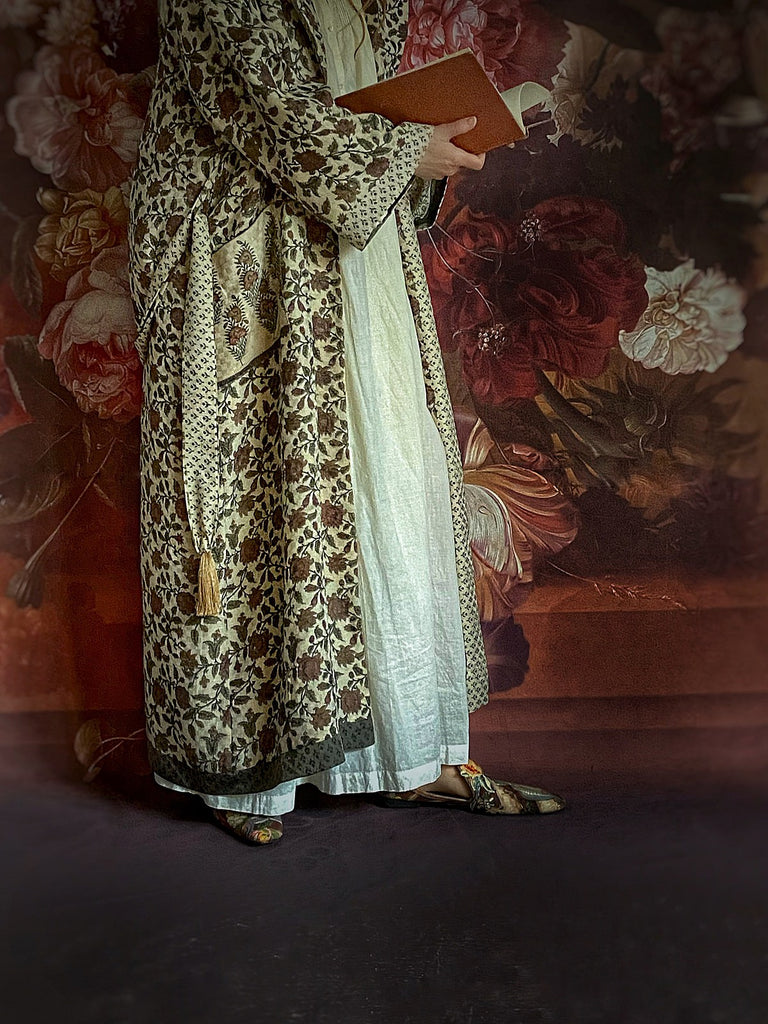 Chestnut brown and olive green fine wool dressing robe or duster coat with a design of Indienne florals. Wide sleeves, deep pockets, tassel sash. Lined in printed silk. Luxury bohemian style sustainably created in the UK from antique and vintage textiles by the Pavilion Parade studio.