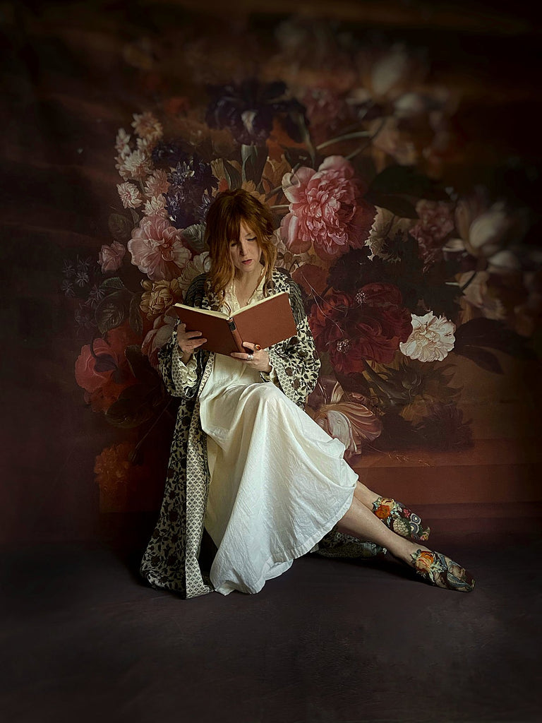 Chestnut brown and olive green fine wool dressing robe or duster coat with a design of Indienne florals. Wide sleeves, deep pockets, tassel sash. Lined in printed silk. Luxury bohemian style sustainably created in the UK from antique and vintage textiles by the Pavilion Parade studio.