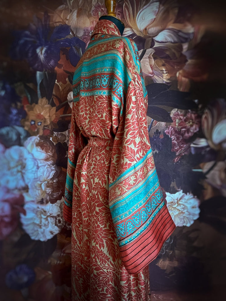 Luxury bohemian dressing robe or duster in a vibrant coral and turquoise palette, with wide sleeves, deep pockets, and tassel sash belt. Fully lined in colourful printed silk. Created from vintage and antique textiles by the Pavilion Parade studio.