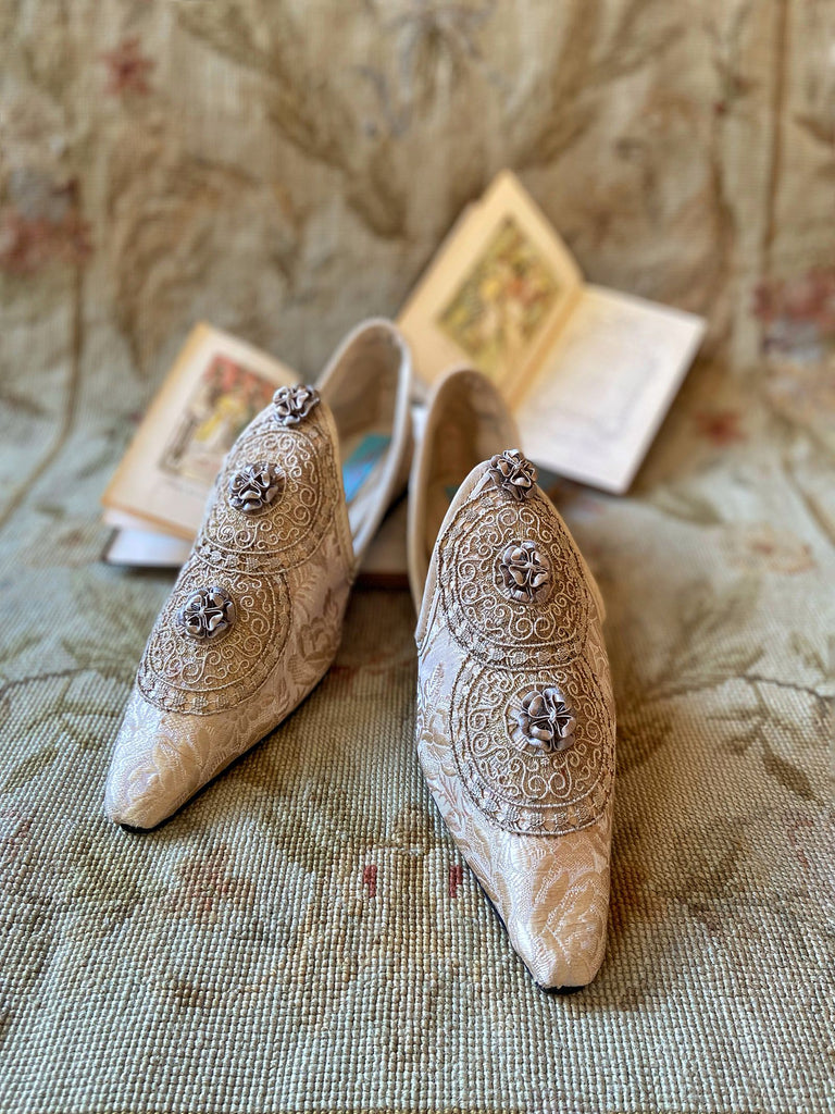 Cream and rose gold silk damask pointed toe shoes  with linen and gold metallic filigree lacework medallions. Finished with little vintage silk passementerie rosettes. Bohemian costume shoes created from antique textiles by Pavilion Parade.
