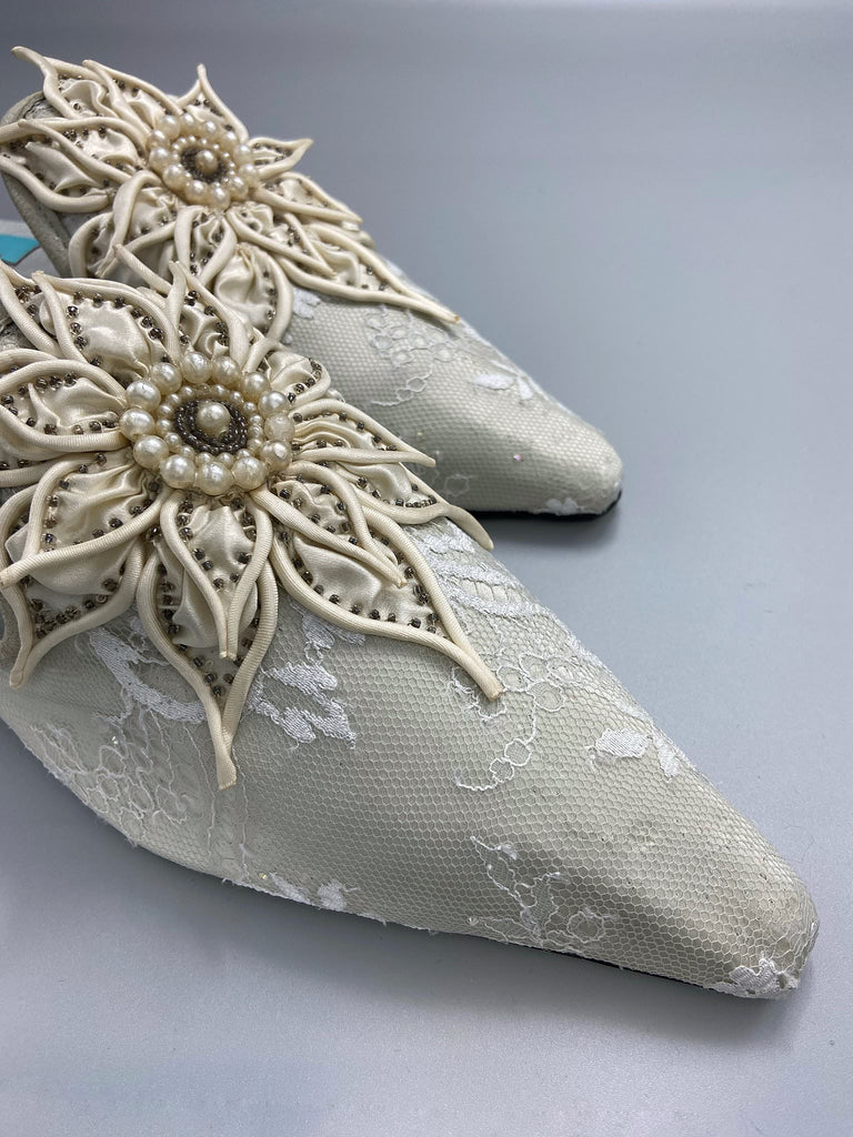 Pointed toe silk satin shoes with antique ivory Edwardian flower and pearl embellishment. Created by Pavilion Parade