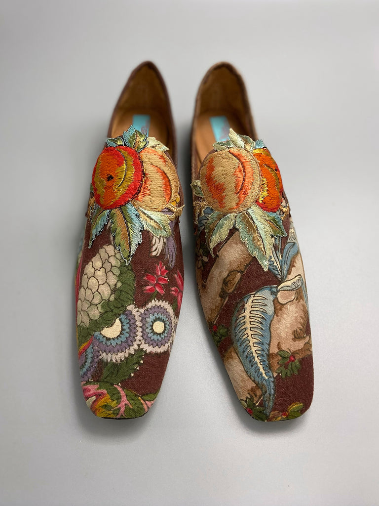 Vibrant colourful bohemian shoes created from an antique French  block printed Indienne cotton, with a design of fantastical flowers and foliage  and embroidered fruits. Sustainably made from antique textiles by Pavilion Parade