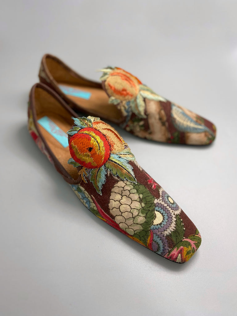 Vibrant colourful bohemian shoes created from an antique French  block printed Indienne cotton, with a design of fantastical flowers and foliage  and embroidered fruits. Sustainably made from antique textiles by Pavilion Parade
