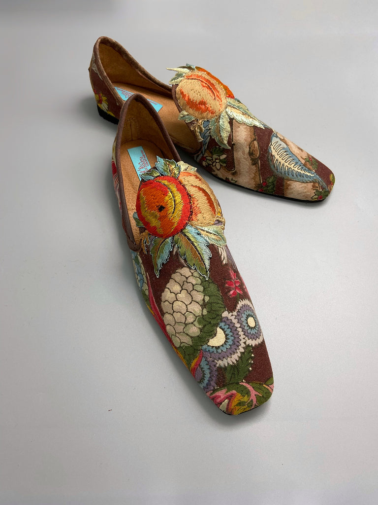 Vibrant colourful bohemian shoes created from an antique French  block printed Indienne cotton, with a design of fantastical flowers and foliage  and embroidered fruits. Sustainably made from antique textiles by Pavilion Parade