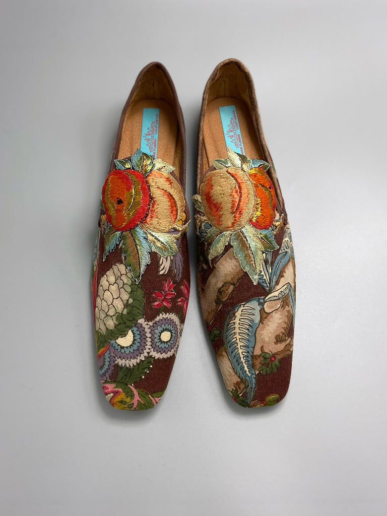Vibrant colourful bohemian shoes created from an antique French  block printed Indienne cotton, with a design of fantastical flowers and foliage  and embroidered fruits. Sustainably made from antique textiles by Pavilion Parade
