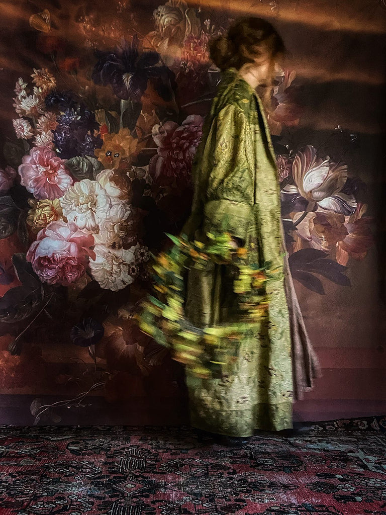 Hand embroidered kantha silk dressing robe or duster coat in an ombré olive green shade with leaf green, burgundy and yellow floral embroidery. Wide sleeves, deep pockets and tassel sash belt. Created from vintage and antique textiles by the Pavilion Parade studio.