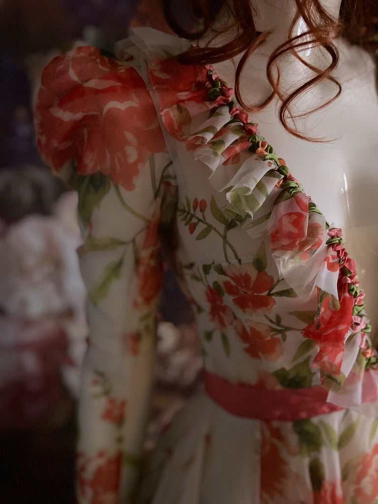 Ivory and coral red floral silk organza ball gown  wedding dress with long puffed sleeves and deep illusion plunge neckline. A Flight of Fancy from Pavilion Parade