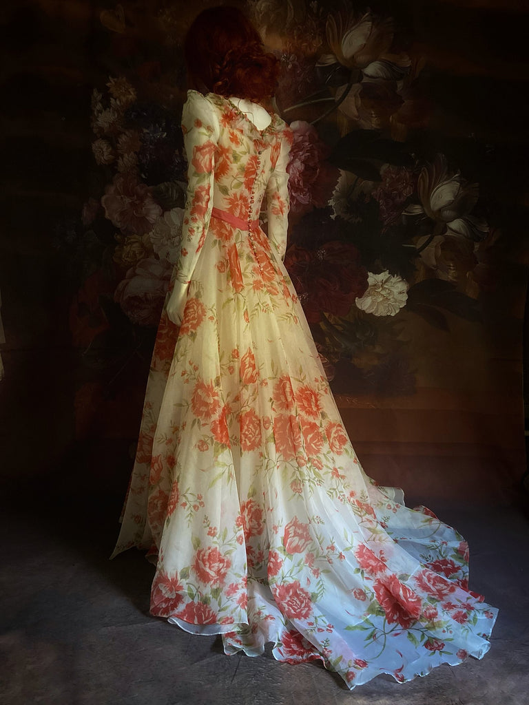 Ivory and coral red floral silk organza ball gown  wedding dress with long puffed sleeves and deep illusion plunge neckline. A Flight of Fancy from Pavilion Parade