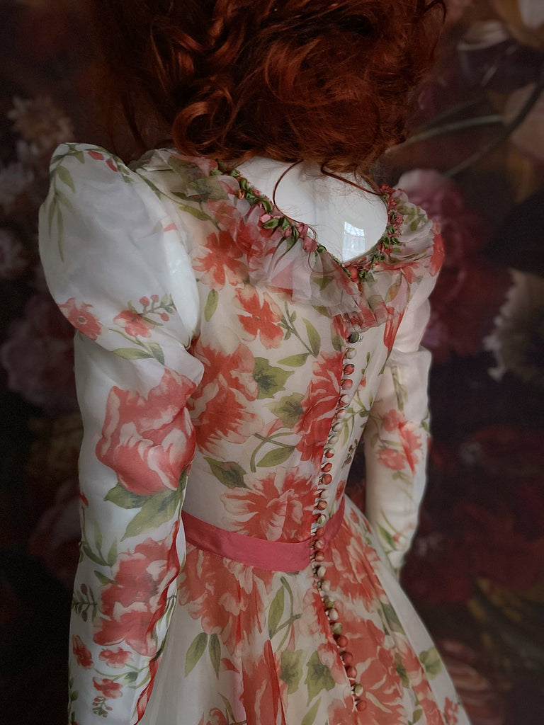 Ivory and coral red floral silk organza ball gown  wedding dress with long puffed sleeves and deep illusion plunge neckline. A Flight of Fancy from Pavilion Parade