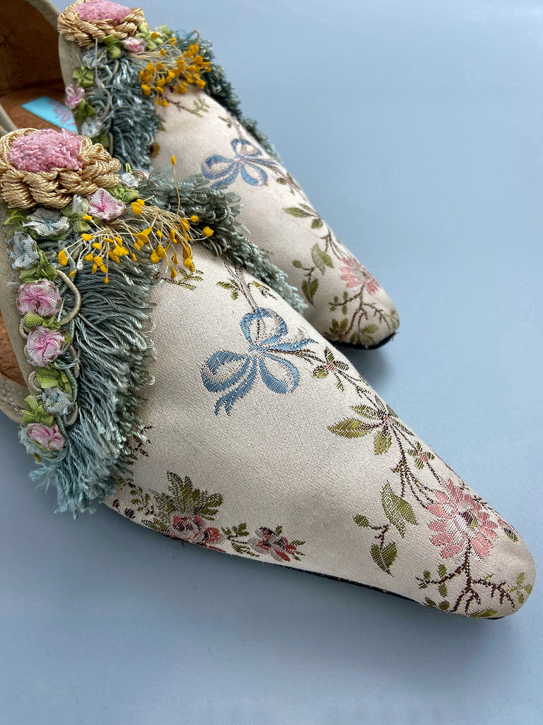 Georgian style silk brocade shoes with blue ribbons and rococo flower trim. Created from antique textiles by the Pavilion Parade studio