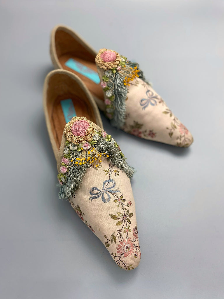 Georgian style silk brocade shoes with blue ribbons and rococo flower trim. Created from antique textiles by the Pavilion Parade studio