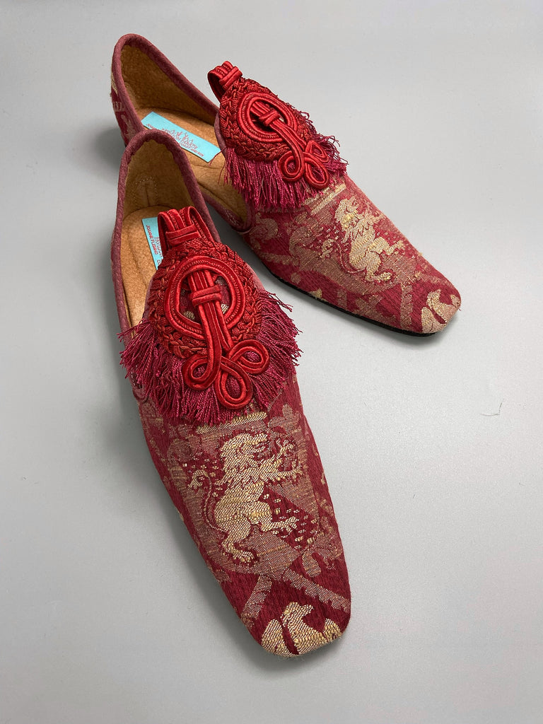 Dark red French brocade slipper shoes with a heraldic design of lions rampant, embellished with antique crimson silk soutache medallions. Created from antique textiles by Pavilion Parade