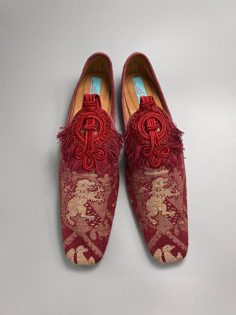 Dark red French brocade slipper shoes with a heraldic design of lions rampant, embellished with antique crimson silk soutache medallions. Created from antique textiles by Pavilion Parade