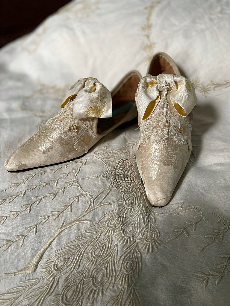 Ivory silk damask bridal boudoir shoes with rococo bows and Victorian tassels. Created from antique textiles by Pavilion Parade