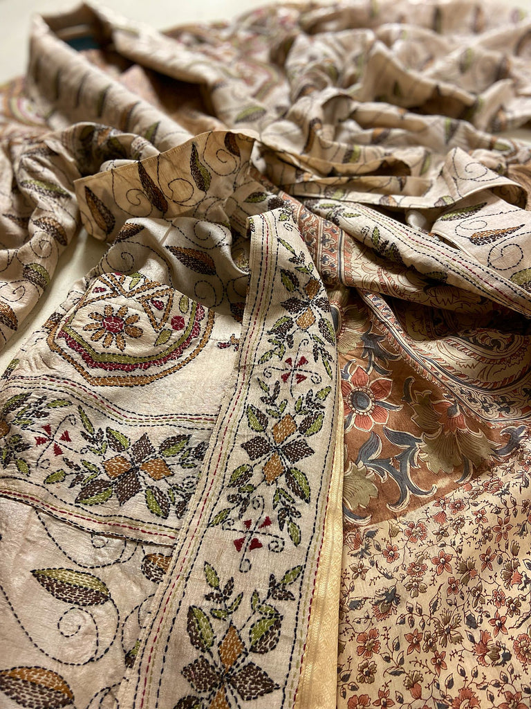 Hand embroidered kantha silk dressing robe or duster coat in an antique ivory shade with leaf green, wine red and chestnut floral embroidery. Wide sleeves, deep pockets and tassel sash belt. Created from vintage and antique textiles by the Pavilion Parade studio.