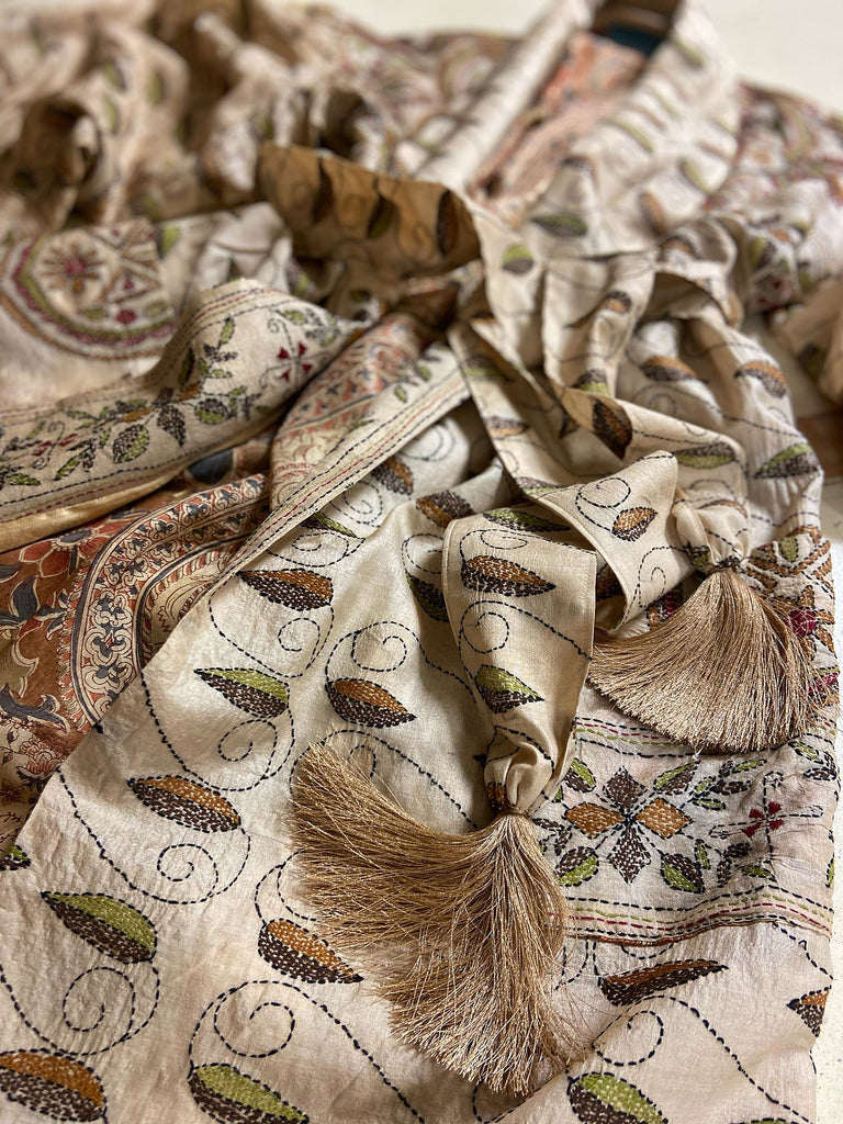 Hand embroidered kantha silk dressing robe or duster coat in an antique ivory shade with leaf green, wine red and chestnut floral embroidery. Wide sleeves, deep pockets and tassel sash belt. Created from vintage and antique textiles by the Pavilion Parade studio.