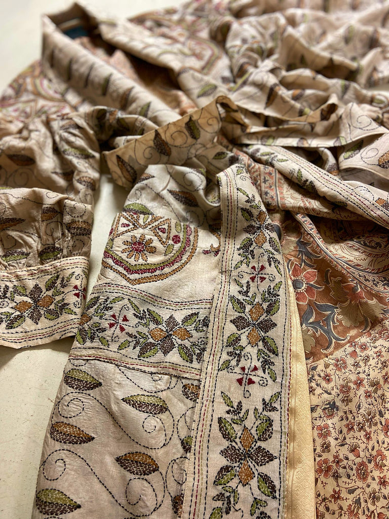 Hand embroidered kantha silk dressing robe or duster coat in an antique ivory shade with leaf green, wine red and chestnut floral embroidery. Wide sleeves, deep pockets and tassel sash belt. Created from vintage and antique textiles by the Pavilion Parade studio.