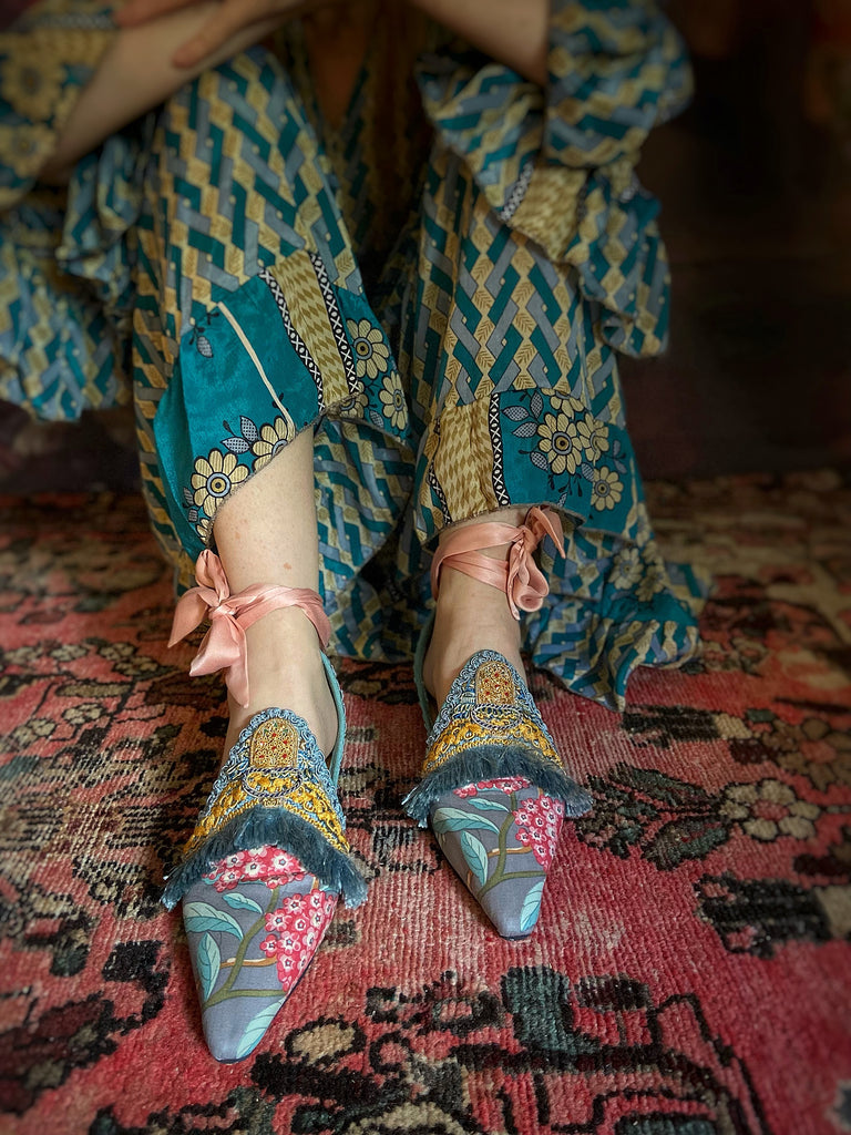 Mitsou Pavilion Parade handmade shoes created from antique textiles,  available from Joanne Fleming Design. Antique French cintz and 19th century passementerie create bohemian flat shoes in shades of pink and teal